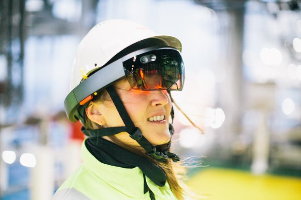 Photo of a woman wearing protective gear and Microsoft Hololens glasses