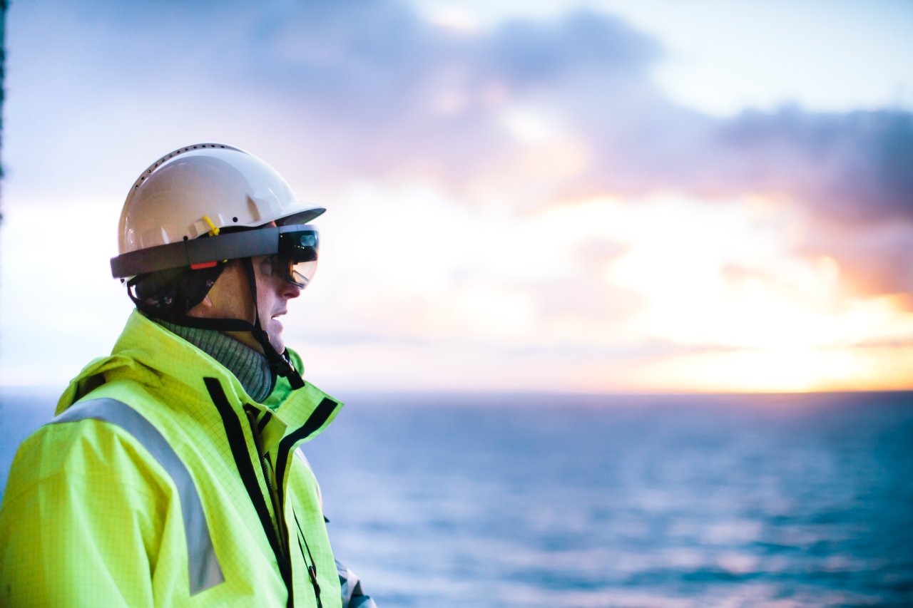 Photo of a man in protective gear standing and looking at the sunset