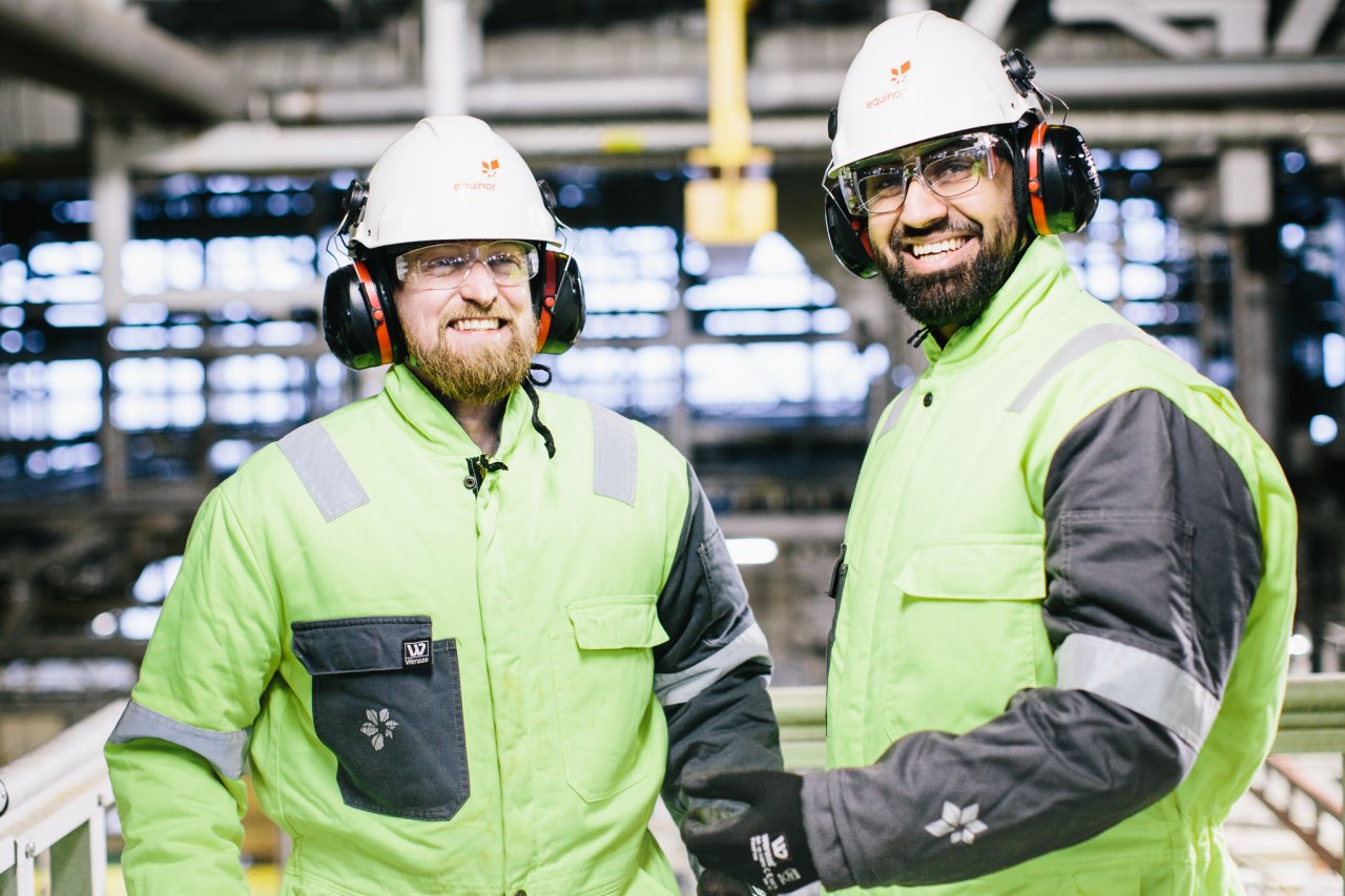 Photo of two smiling men wearing protective gear 