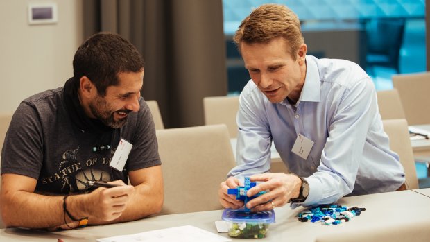 Two men sitting and building something with LEGO during the Equinor Developer Conference