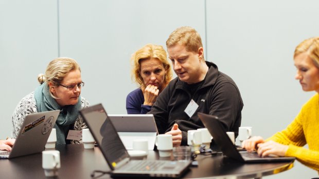Man showing something on a computer to two women during a workshop at EDC
