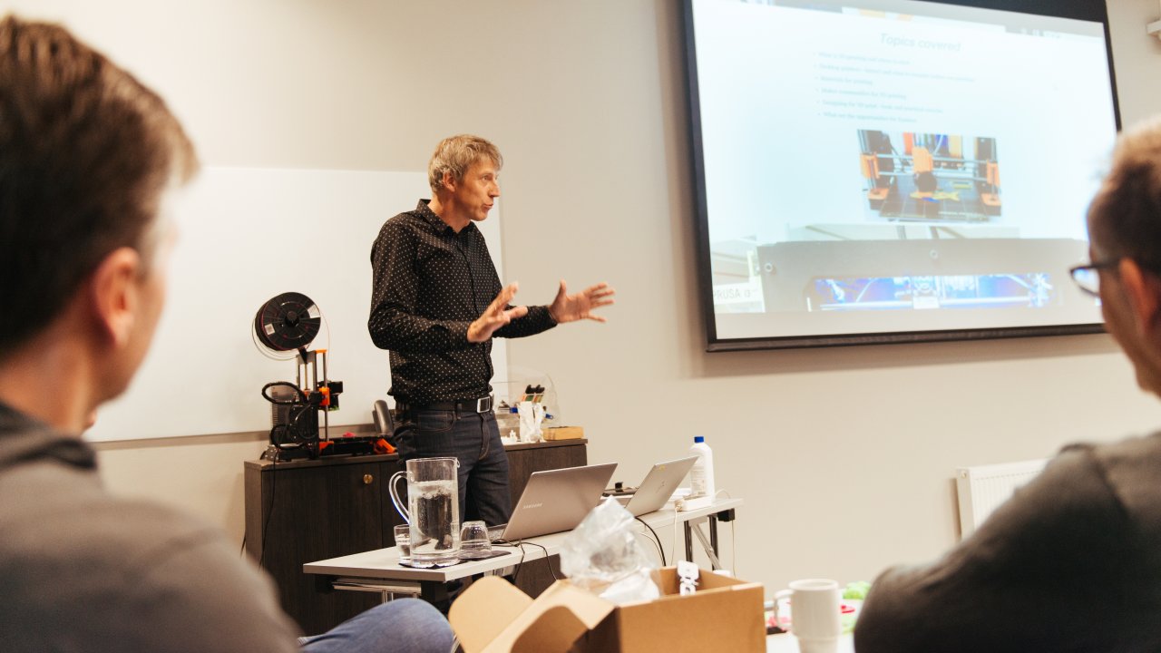 Photo of a man giving a presentation at a conference workshop