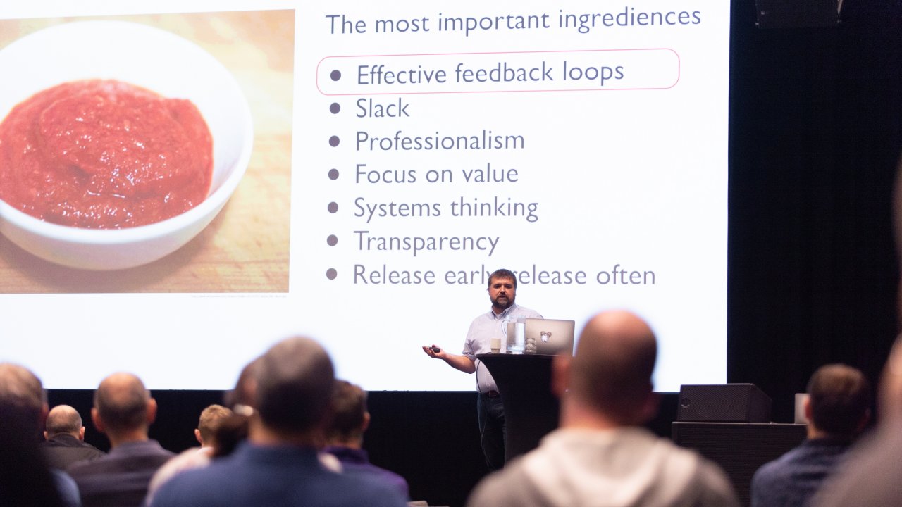 Photo of a man giving a presentation at a conference