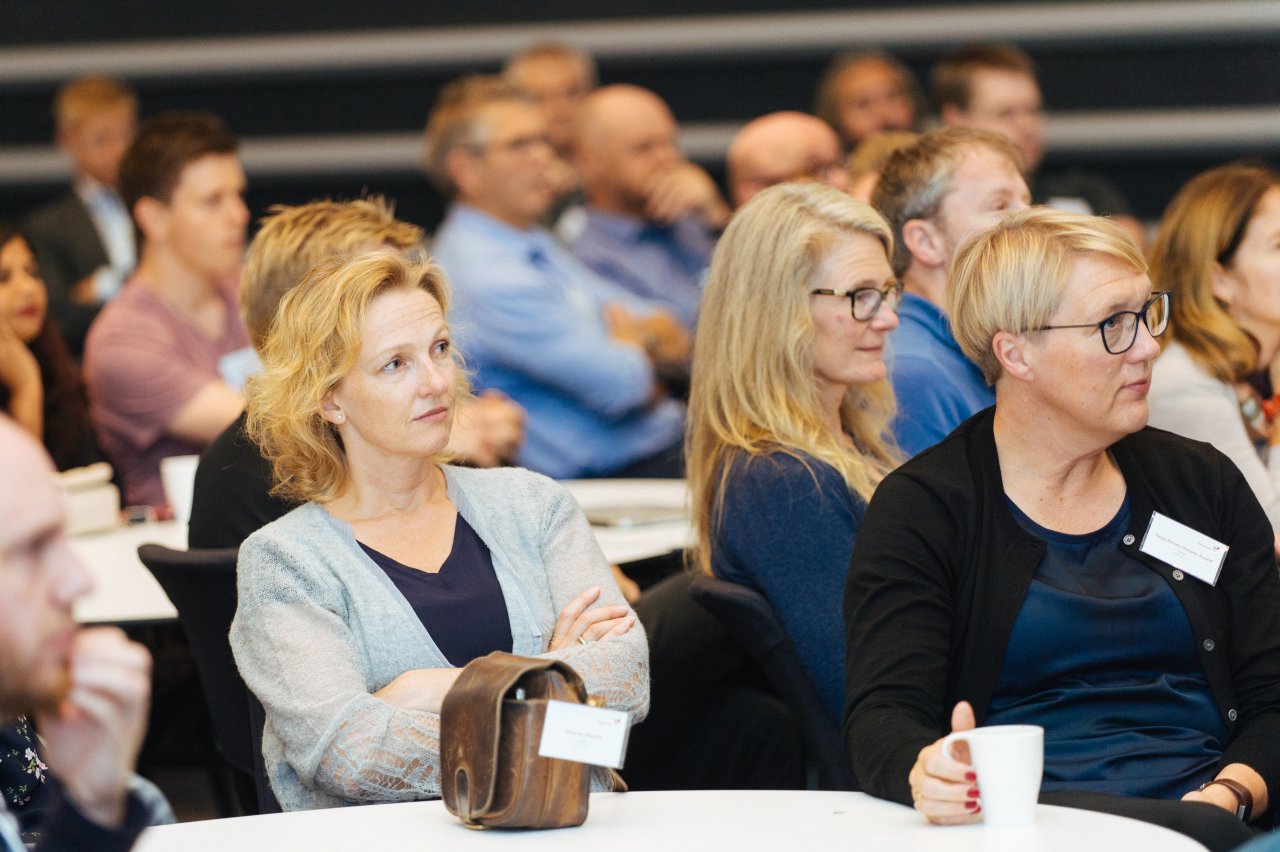 Group of people sitting and listening attentively from the audience at EDC, Equinor's own software developer conference