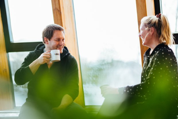 Photo of Lars-Sverre Eriksen and Lavinia Chrystal, who work as UX designers in Equinor, having a coffee and talking