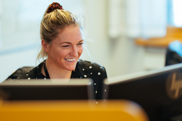 Photo of a UX designer in Equinor working at her computer